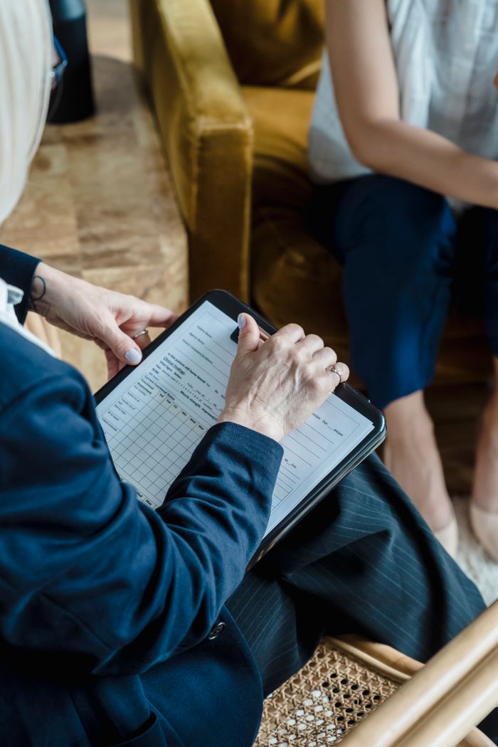 services-01 Hands holding a clipboard in a professional setting during a counseling session.